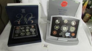 A 2005 UK Battle of Trafalgar Nelson proof set and a Year 2000 executive proof coin collection.