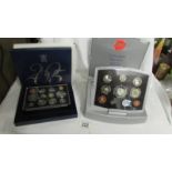 A 2005 UK Battle of Trafalgar Nelson proof set and a Year 2000 executive proof coin collection.