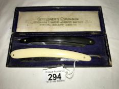 2 vintage cut throat razors in a case.