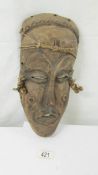 A carved hard wood tribal mask.