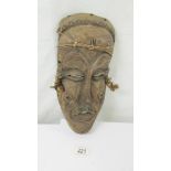 A carved hard wood tribal mask.