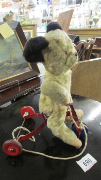 A circa 1950's pull along bear on scooter.(Height 29cm.) - Image 2 of 2