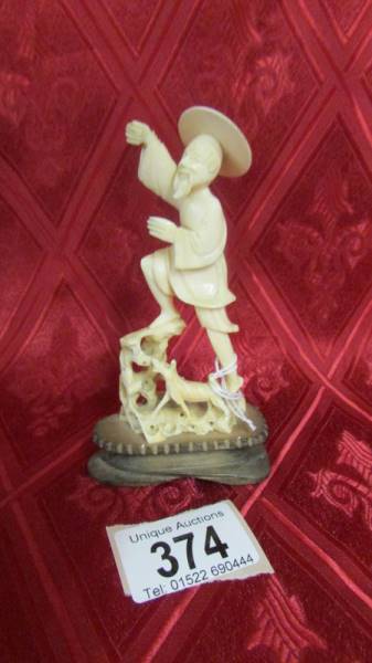 An antique carved ivory figure. Available for UK shipping only.