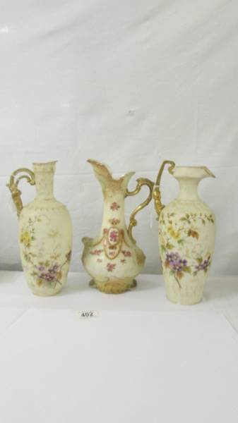 Three floral decorated cream glass vases (one has chip to base).
