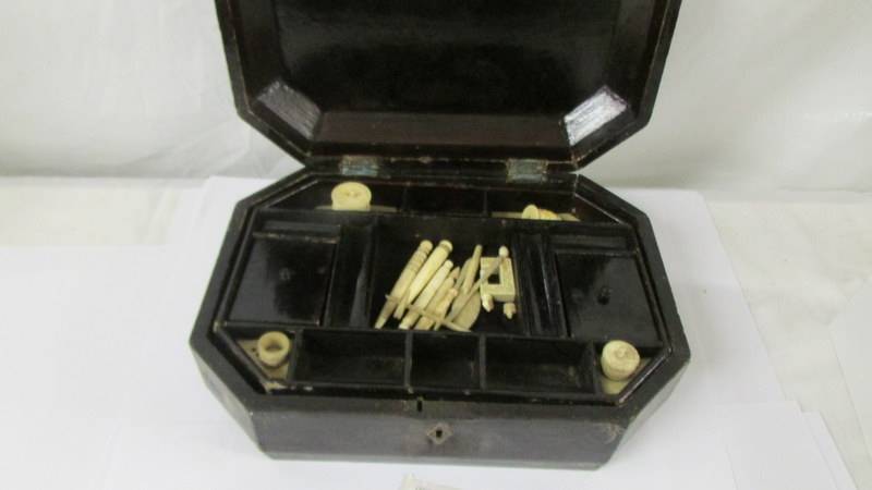 A Chinese lacquered work box with bone tools, needle holder, thread holder and bag of seashells - Image 2 of 3
