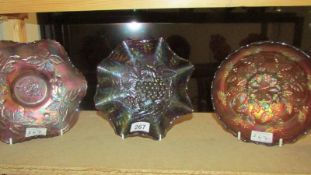 Three carnival glass bowls including Fenton amethyst autumn acorns, Fenton marigold holly and one