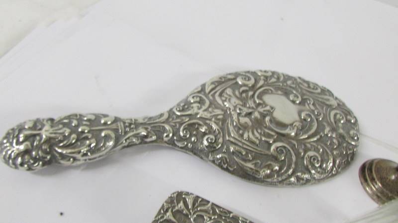 A silver backed hand mirror, a silver topped trinket pot, a silver spill vase and a silver topper - Image 3 of 4