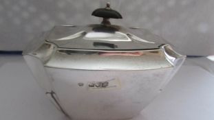 A silver sugar bowl with cover.