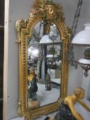 An elaborate Elizabethan style wall mirror with sun burst face in top, 97 x 50 cm. Collect only.