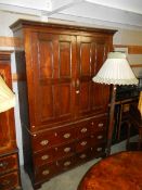 A Victorian oak two door drawer based cupboard.