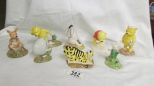 Eight Royal Doulton Winnie the Pooh series figurines.
