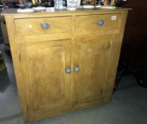 An antique pine kitchen cupboard with drawers