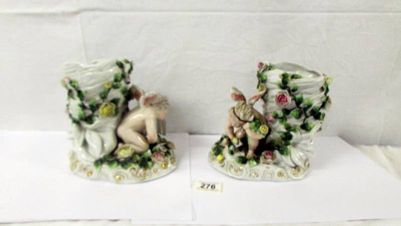 A pair of 19th century continental porcelain cherub vases (possibly Szitzendorf).