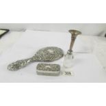 A silver backed hand mirror, a silver topped trinket pot, a silver spill vase and a silver topper