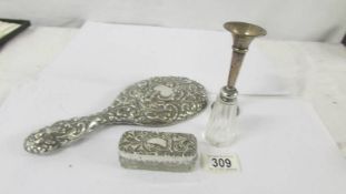 A silver backed hand mirror, a silver topped trinket pot, a silver spill vase and a silver topper