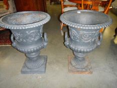 A pair of mid-late 20th century cast iron garden urns. 30" tall x 22.5" diameter.