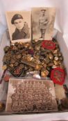 A large tray of assorted military buttons and some cap badges.