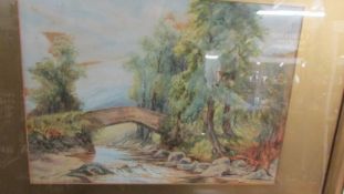 A framed and glazed watercolour bridge scene signed Robinson 1922.