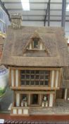 An impressive Tudor style doll's cottage complete with dolls and furnishings