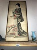 A late 19th century Japanese watercolour on silk of a Geisha girl standing before a floral screen.
