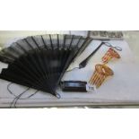 Two vintage fans, pince ney with holder, 2 hair combs and a lacquered snuff box.