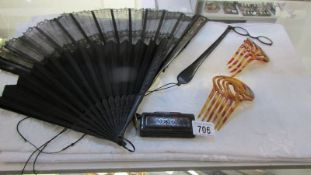 Two vintage fans, pince ney with holder, 2 hair combs and a lacquered snuff box.