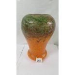 A 12" high Monart glass vase, bottom part orange and top green with golden flecks. No visible