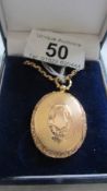 A 15 ct gold locket. 10 grams, on a gold chain 8.8 grams.