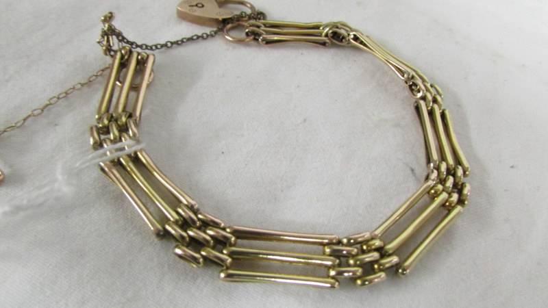 An early 20th century rose gold bracelet with chased gold inserts and heart lock, 11.2 grams. - Image 2 of 2