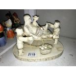 A resin oriental faux ivory figure group