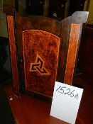 A Small arts and crafts hanging table/cabinet inlaid in a variety of woods.