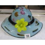 A fabulous studio glass hat with applied flower. Collect only.