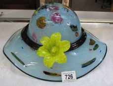 A fabulous studio glass hat with applied flower. Collect only.