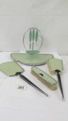 An art deco dressing table set comprising tray with manicure items. hand mirror and two brushes.