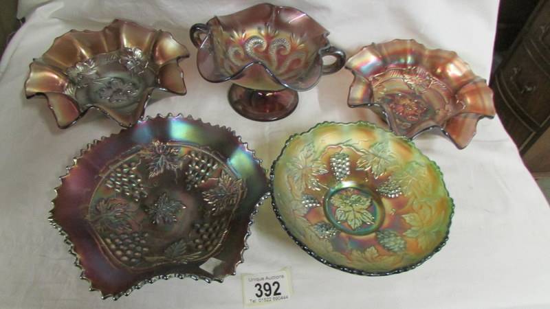 Five carnival glass bowls including Fenton green leaf, Dugan amethyst apple blossom, Northwood Grape