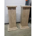 Two square heavy marble columns, 70 cm tall.