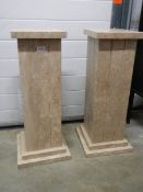Two square heavy marble columns, 70 cm tall.