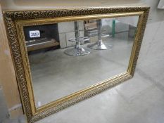 A gilt framed bevel edged mirror. 86 x 56 cm.