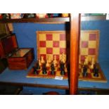 An old wooden chess set with board.