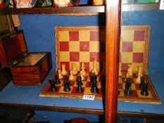 An old wooden chess set with board.