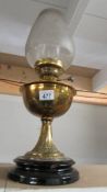 A brass oil lamp on pot base. Collect only.