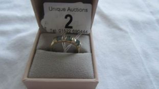 A 9ct gold three stone aquamarine ring, size S.