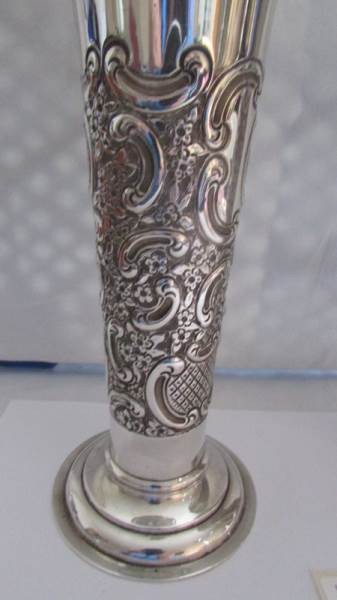 A pair of silver embossed vases. - Image 3 of 4