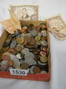 A mixed lot of coins and bank notes.