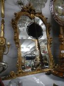 An ornate Regency style gilded wall mirror, 108 x 89 cm, in good condition. Collect only.