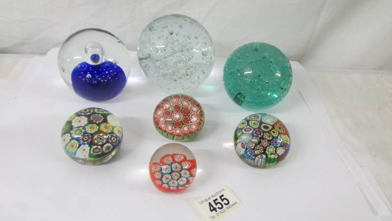 Four millifiori glass paperweight and three large glass paperweights.