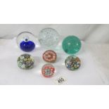 Four millifiori glass paperweight and three large glass paperweights.