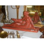 A signed deco figure of a lady with dog in red ochre, inscribed Felanis. Collect only.