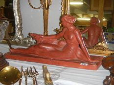 A signed deco figure of a lady with dog in red ochre, inscribed Felanis. Collect only.