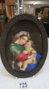 A superb oval framed painting on porcelain of Madonna and child, 19 x 14 cm.